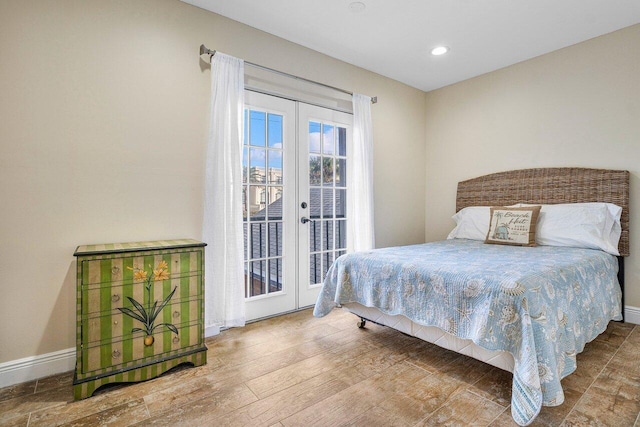 bedroom featuring hardwood / wood-style floors, access to exterior, and french doors