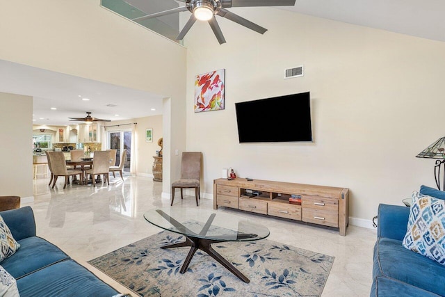 living room with ceiling fan and high vaulted ceiling