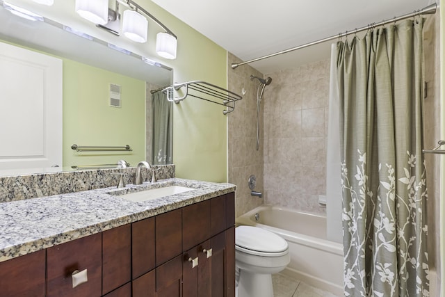 full bathroom featuring tile patterned flooring, vanity, toilet, and shower / bath combo with shower curtain