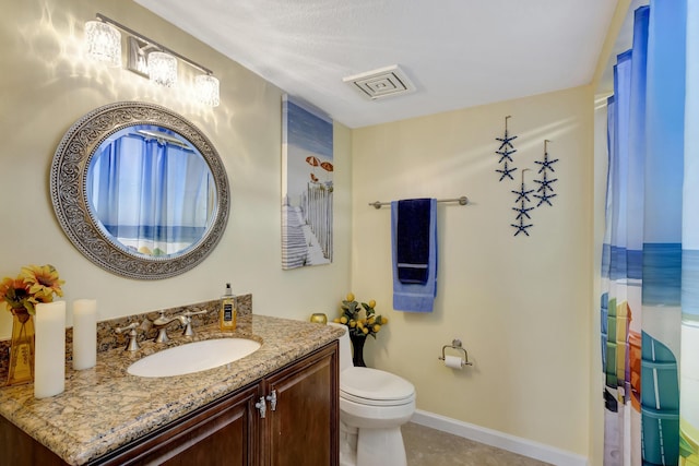 bathroom featuring tile patterned flooring, vanity, and toilet