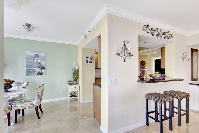 kitchen with crown molding and a breakfast bar