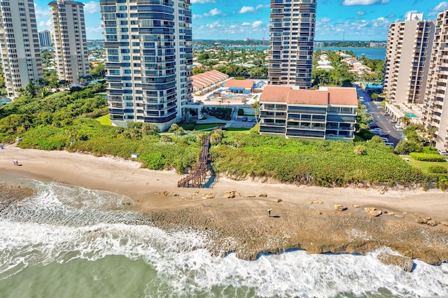 drone / aerial view featuring a water view and a beach view