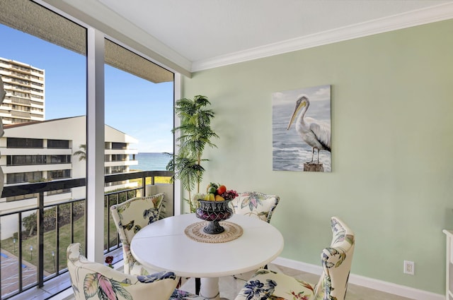 dining space featuring a water view, tile patterned floors, and crown molding