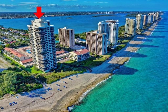 drone / aerial view with a water view and a beach view