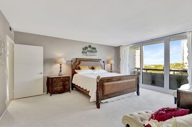 bedroom with floor to ceiling windows, access to exterior, and light carpet