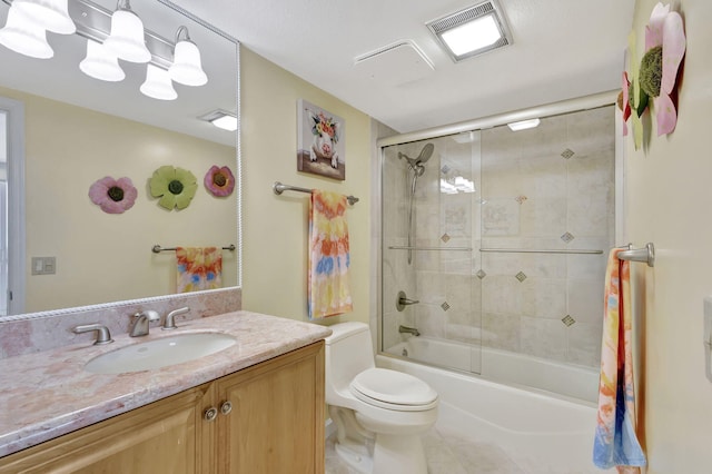 full bathroom with vanity, toilet, and bath / shower combo with glass door