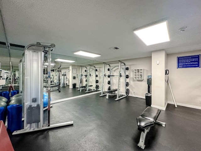 workout area featuring a textured ceiling