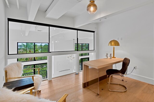 office space featuring hardwood / wood-style floors and beam ceiling