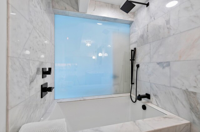 bathroom with a tile shower and tile walls