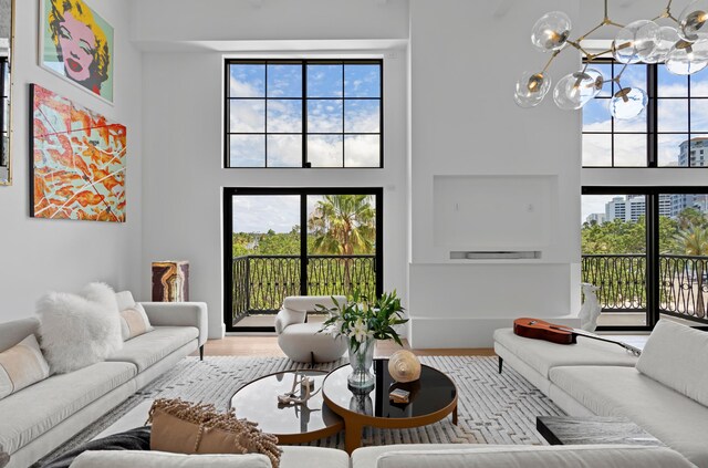 living room with light hardwood / wood-style floors and a notable chandelier