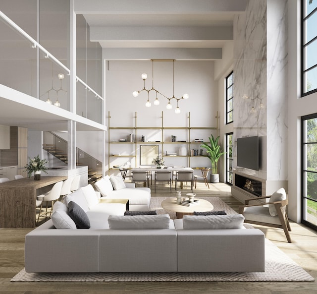 101 N Clematis St Unit 315, West Palm Beach, FL 33401 - living room with a towering ceiling, plenty of natural light, wood finished floors, a high end fireplace, and a chandelier
