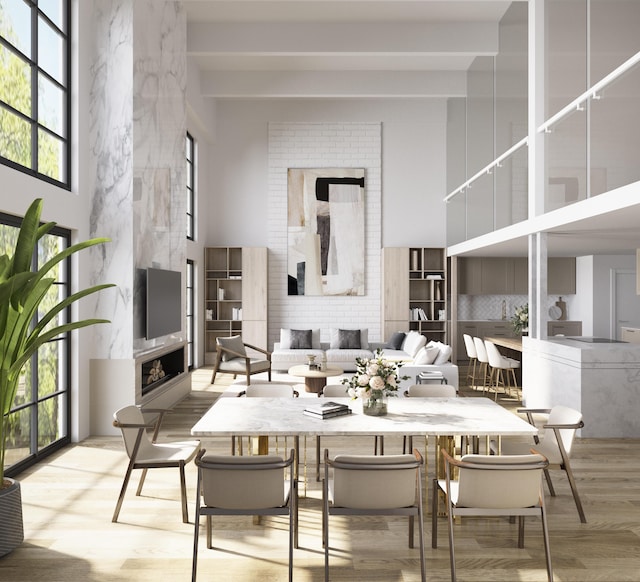 101 N Clematis St Unit 315, West Palm Beach, FL 33401 - dining area featuring a fireplace, a high ceiling, and wood finished floors