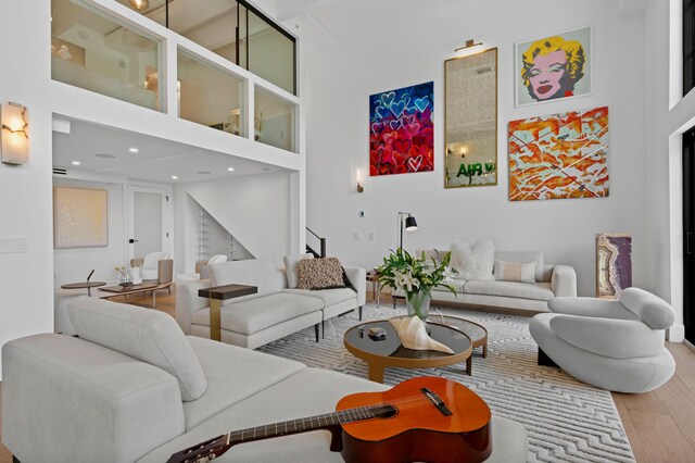 living room with a high ceiling and hardwood / wood-style flooring