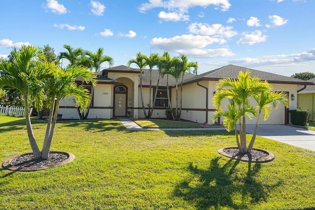 view of front of house featuring a garage and a front yard