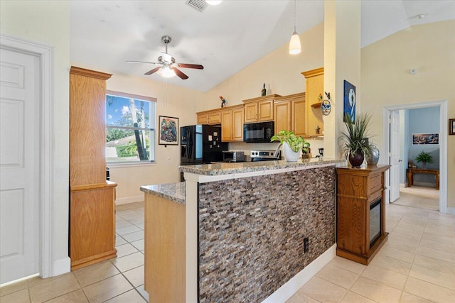 kitchen with black appliances, ceiling fan, light tile patterned floors, light stone counters, and kitchen peninsula