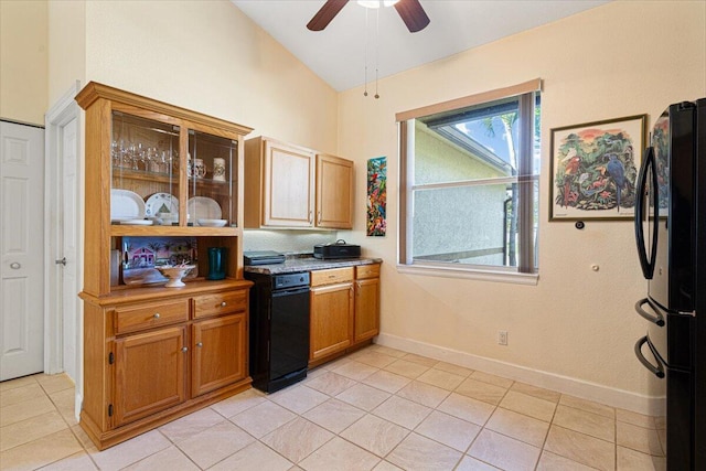 kitchen featuring ceiling fan, black fridge, lofted ceiling, and light tile patterned floors