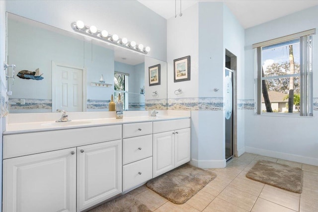 bathroom with tile patterned floors, a shower with door, and vanity