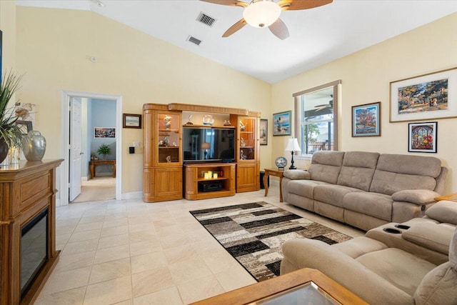 tiled living room featuring ceiling fan and vaulted ceiling