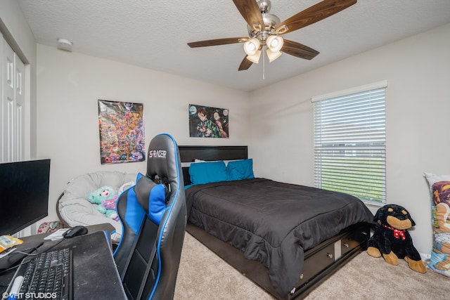 bedroom with light carpet, a textured ceiling, a closet, and ceiling fan