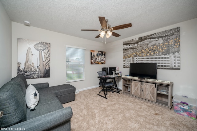 carpeted home office featuring ceiling fan and a textured ceiling