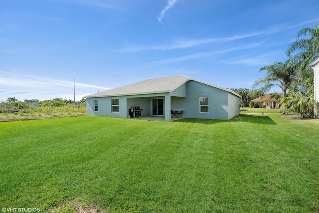 back of property with a lawn