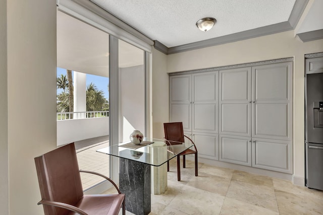 sitting room featuring crown molding and a textured ceiling