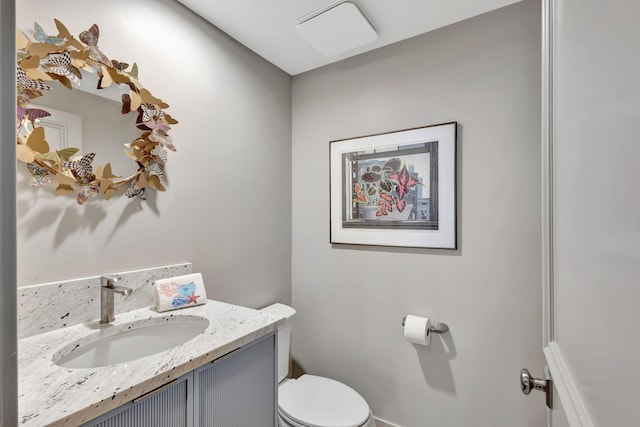 bathroom featuring vanity and toilet