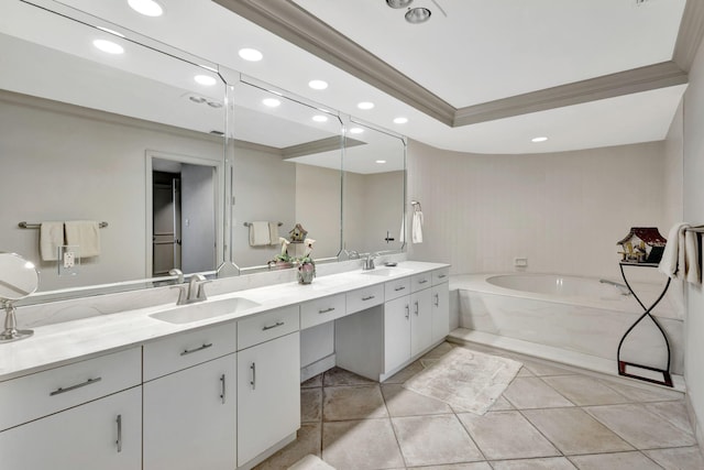 bathroom with vanity, tile patterned floors, ornamental molding, a tub to relax in, and a tray ceiling