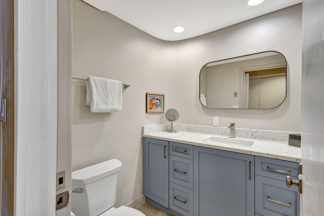 bathroom featuring tile patterned floors, vanity, and toilet