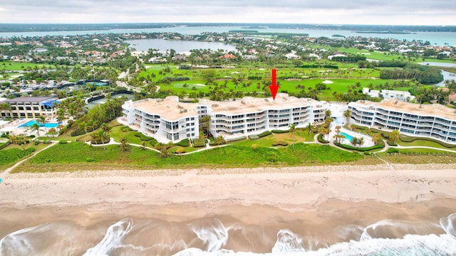 bird's eye view featuring a water view and a view of the beach