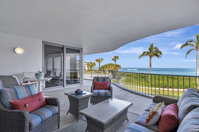 view of patio with a water view, an outdoor hangout area, and a balcony