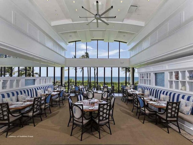 interior space with a water view and ceiling fan