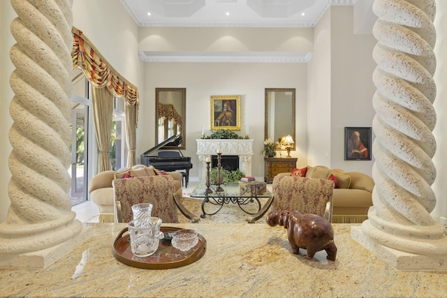 living room with a towering ceiling and crown molding