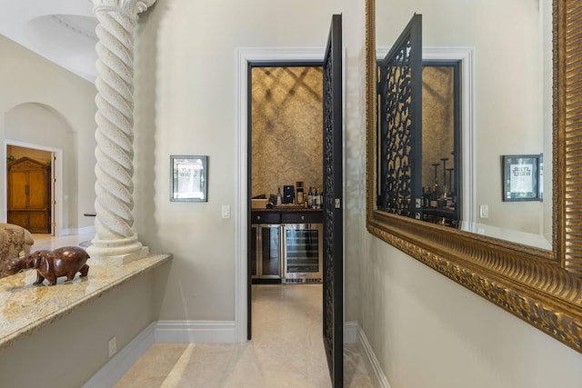 hallway with light tile patterned floors and beverage cooler