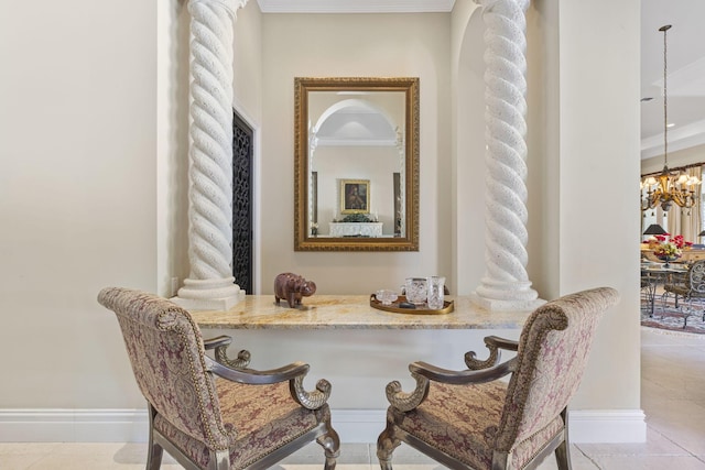 living area featuring decorative columns, an inviting chandelier, ornamental molding, and light tile patterned flooring