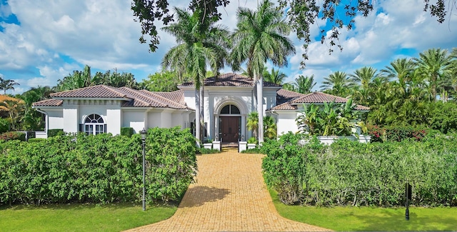 mediterranean / spanish-style house with a front yard