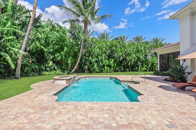 view of pool with a patio area, an in ground hot tub, a yard, and pool water feature