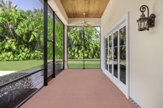 unfurnished sunroom with ceiling fan and wood ceiling