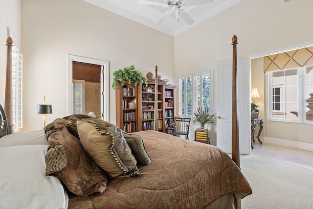 tiled bedroom featuring ceiling fan, ornamental molding, and a towering ceiling