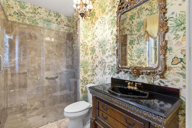 bathroom with tile patterned floors, vanity, an enclosed shower, and toilet