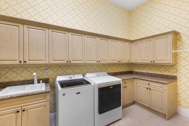 clothes washing area featuring cabinets, separate washer and dryer, light tile patterned flooring, and sink