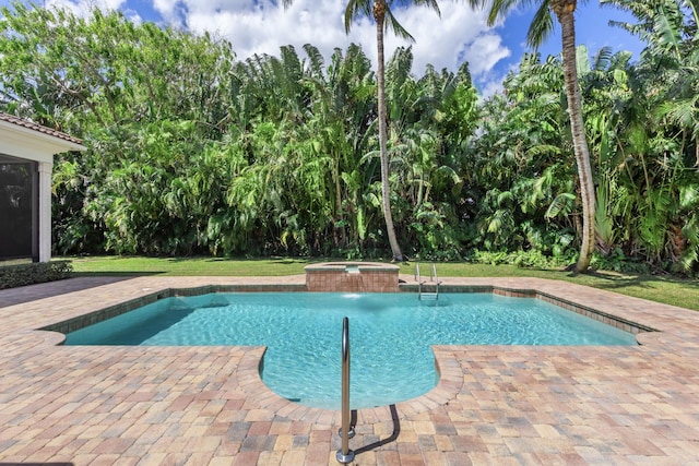 view of pool featuring a patio area, an in ground hot tub, and a yard