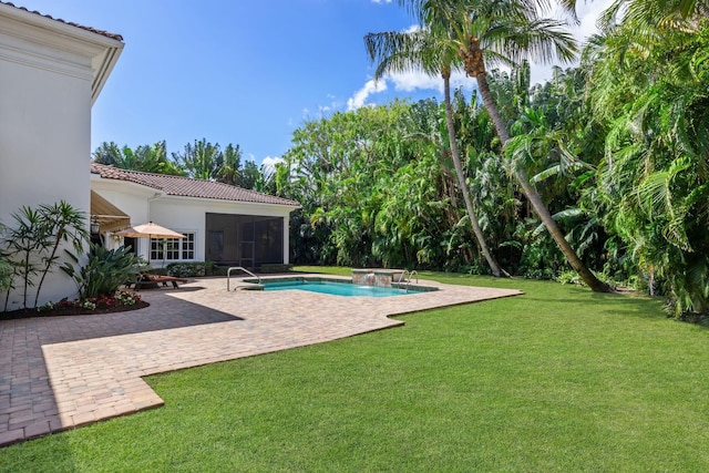 view of pool with a jacuzzi, a yard, a patio, and a sunroom