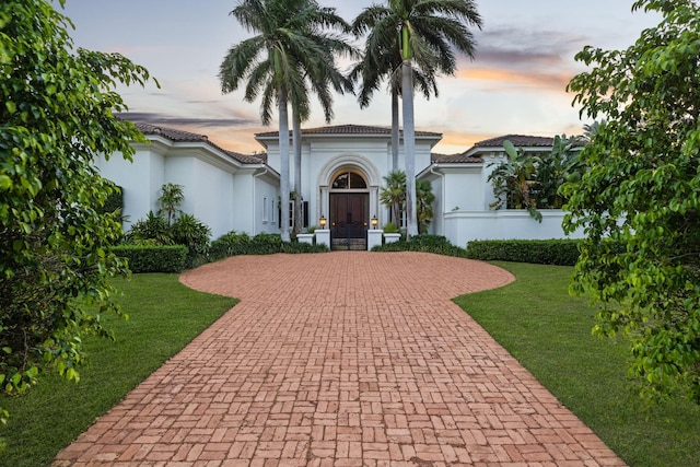 mediterranean / spanish-style house featuring a yard