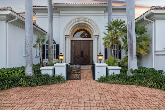 view of exterior entry at dusk