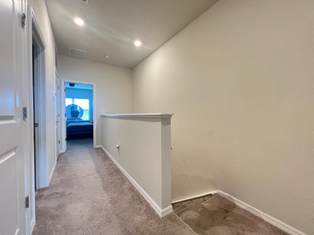 hallway with light colored carpet