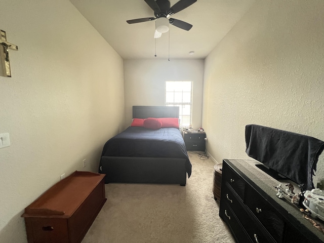 bedroom with light carpet and ceiling fan