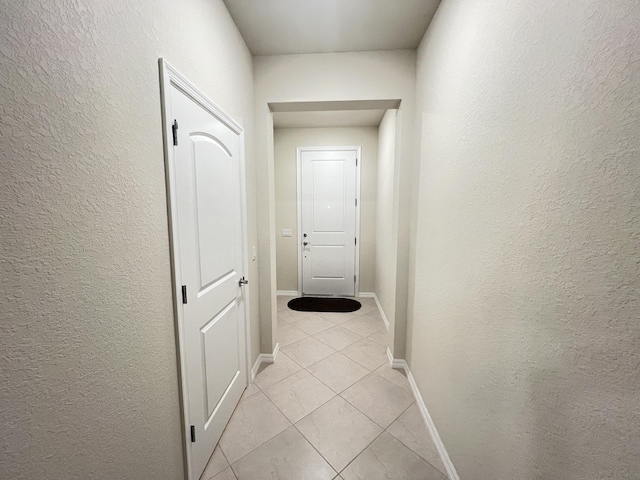 hallway with light tile patterned flooring