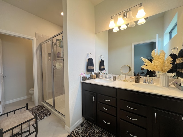 bathroom featuring toilet, vanity, and walk in shower