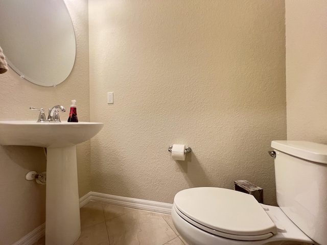 bathroom featuring tile patterned floors and toilet